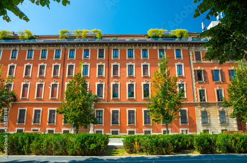 Orange multi-storey buildings with rows of windows, Milan, Italy