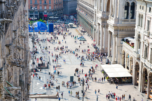 Fototapeta Naklejka Na Ścianę i Meble -  Crowd small figures of people on Piazza del Duomo square, Milan, Italy