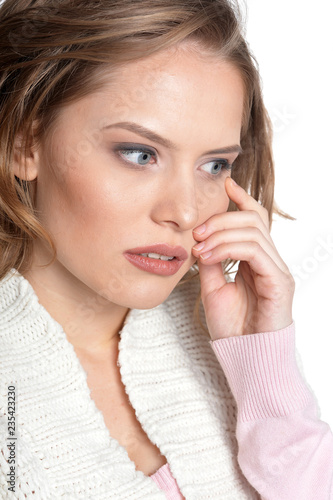 Portrait of sad young woman on white background