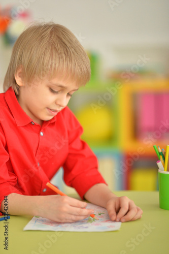 Portrait of a cute little boy drawing