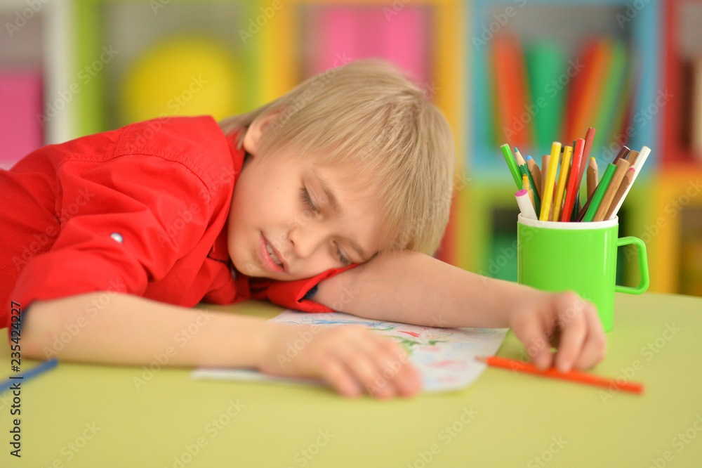 Portrait of cute little boy sleeping on table Portrait of cute little boy sleeping on table