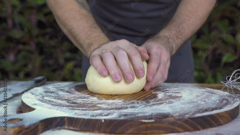 Chef cook kneading dough for pie baking close up. Chef cook making dough for baking cake on wooden table. Process preparation homemade pastry. Cooking bakery products, food concept. Chef cook kneading dough for pie baking close up. Chef cook making dough for baking cake on wooden table. Process preparation homemade pastry. Cooking bakery products, food concept.