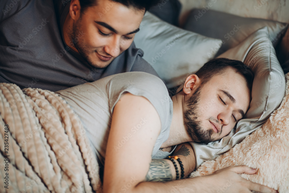 Erotic gay caucasian couple bonding at bed, sleeping, tired after sleepless  hot night, Same-sex relationship and family concept. Stock Photo | Adobe  Stock