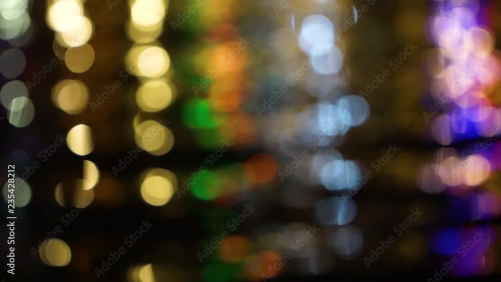 Beautiful multicolor holiday background. Defocused shiny lights of yellow, gold, orange, green, red, purple and blue colors on black background. Real time full hd video footage. Beautiful multicolor holiday background. Defocused shiny lights of yellow, gold, orange, green, red, purple and blue colors on black background. Real time full hd video footage.