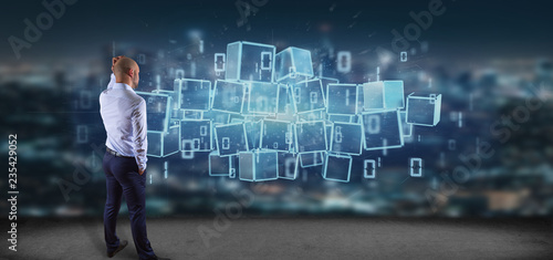 Businessman in front of a Cloud of blockchain cube and binary data 3d rendering