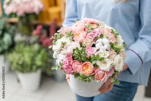 floral bunch in head box. European floral shop. Bouquet of beautiful Mixed flowers in woman hand. Excellent garden flowers in the arrangement , the work of a professional florist.
