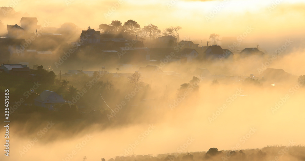 Fototapeta premium Fantastic foggy village in the sunlight in Dalat, Vietnam