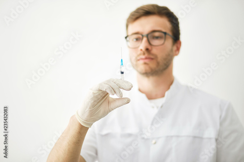 Syringe, medical injection in therapist hands. close up photo. studio shot. isolated background. copy space photo