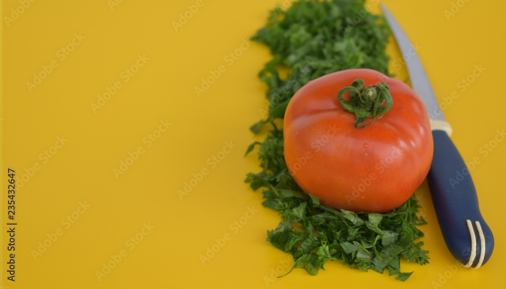 Tomato with herbs and knife. Tomato with herbs and knife.
