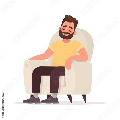 Bearded man sits in an armchair and sleeps. A person is resting or thinking about something good