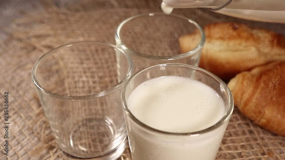 healthy eating, diet and drinks concept - hand pouring milk into glass. very tasty Breakfast healthy eating, diet and drinks concept - hand pouring milk into glass. very tasty Breakfast