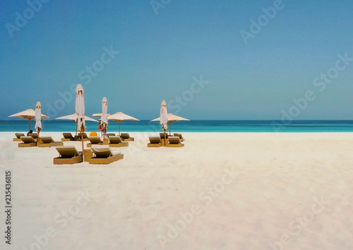 Photography Beautiful beach with an umbrella on the shore of the Arabian Gulf