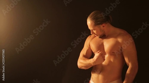 Sexy, brawny man on a black background