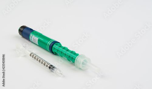 Insulin syringe and insulin injection pen on white background.