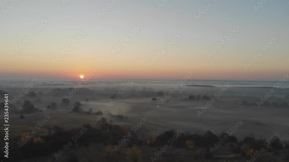 Aerial View. Flying in fog, fly in mist. Aerial camera shot. Flight above the clouds towards the sun. Misty weather, view from above. Birds point of view Aerial View. Flying in fog, fly in mist. Aerial camera shot. Flight above the clouds towards the sun. Misty weather, view from above. Birds point of view