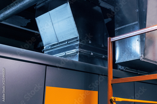 Close-up view of the modern big dimensions ductwork installed on the ceiling of the ventilation plant room