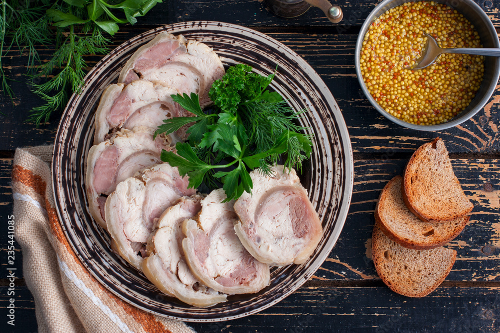 Boiled pork roll with chicken fillet and spices on a wooden table, top view, horizontal Boiled pork roll with chicken fillet and spices on a wooden table, top view, horizontal