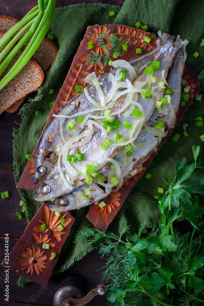 Stewed fish Ryapushka with onions, top view, selective focus