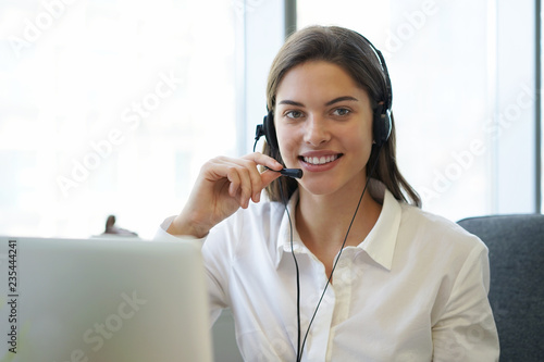 Customer support operator working in a call center office.