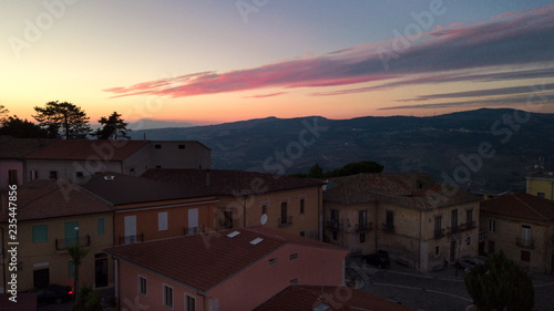 Aerial view at sunset of the small town of Montecalvo Irpino, in the province of Avellino, in Italy. This village with few houses and streets is built in the mountains of Irpinia. © Stefano Tammaro