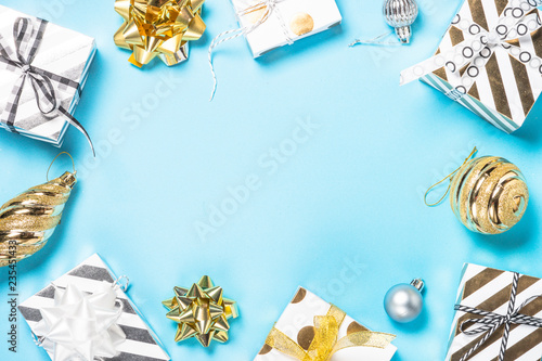 Christmas flatlay background - silver and gold decorations on blue.