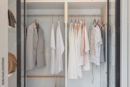 modern closet with clothes hanging on rail © 290712