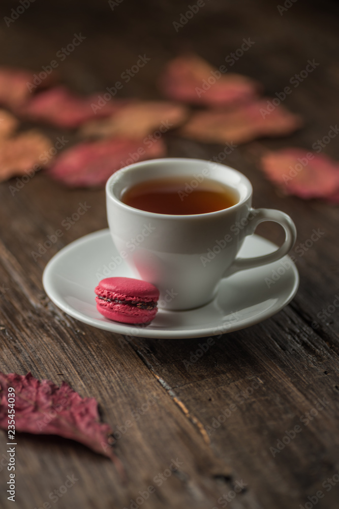 Autumn still life of colorful leaves, a Cup of tea, on an old brown wooden table Autumn still life of colorful leaves, a Cup of tea, on an old brown wooden table