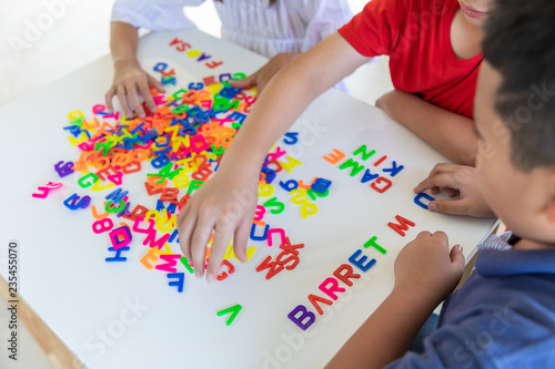 children playing jigsaw letters on the table