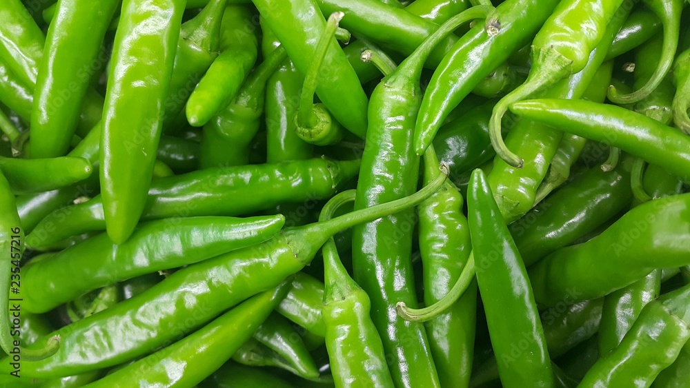 pile of green chili pepper in harvest season placed in a market pile of green chili pepper in harvest season placed in a market
