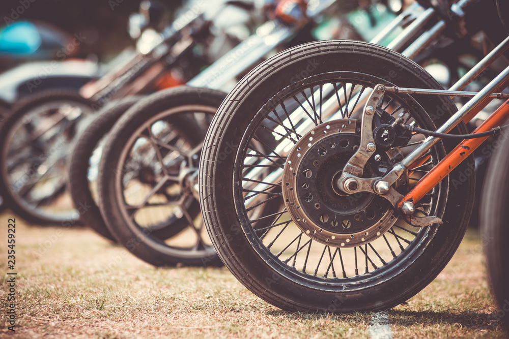 Front wheels of motorcycles exposed in a parking lot