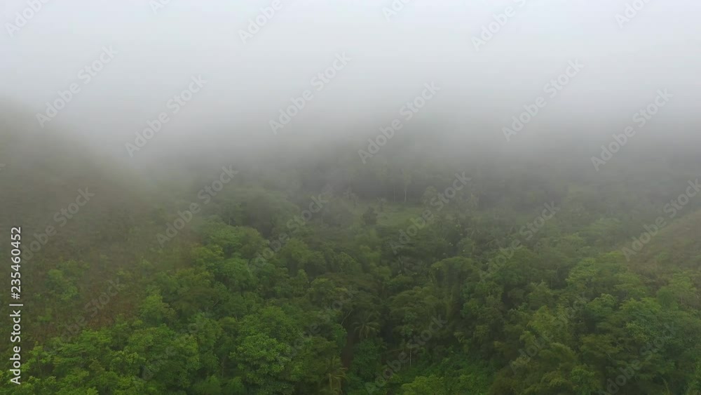 Aerial view of Chocolate Hills, picturesque geological formation on Bohol island, low-level clouds - landscape panorama of Philippines from above, Asia Aerial view of Chocolate Hills, picturesque geological formation on Bohol island, low-level clouds - landscape panorama of Philippines from above, Asia