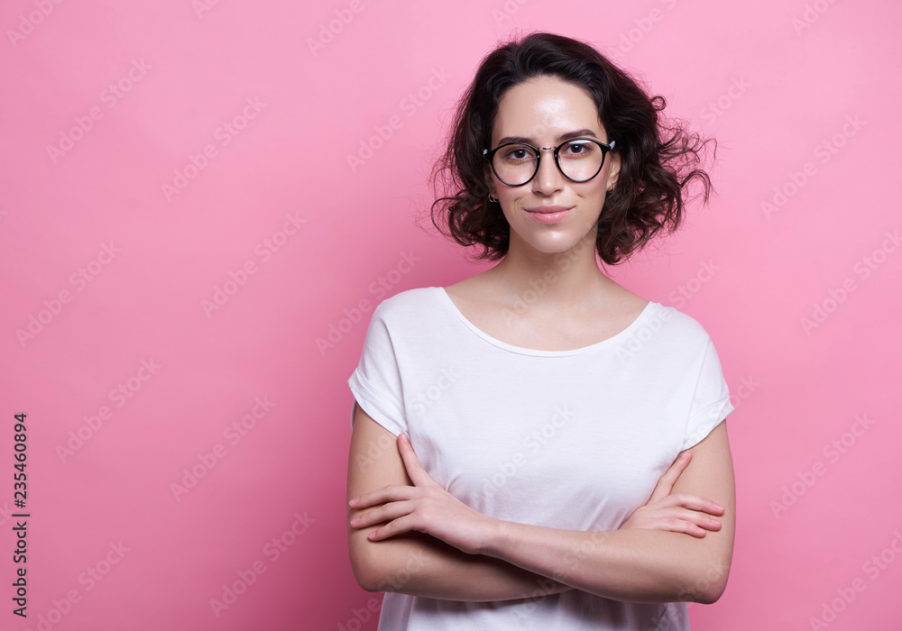 Fototapeta premium Studio shot of good looking intelligent female professor, have no much experience, wears big round spectacles. Caucasian college student recieves good proposal
