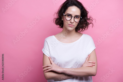 Studio shot of good looking intelligent female professor, have no much experience, wears big round spectacles. Caucasian college student recieves good proposal