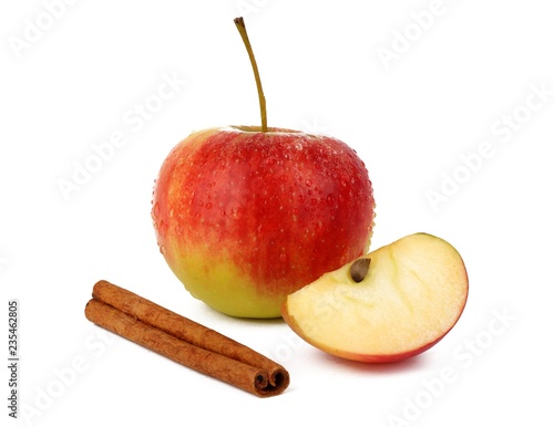 
Red ripe apple and aromatic cinnamon sticks on white background