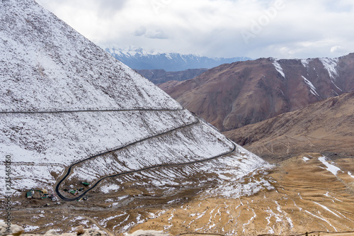 The road and mountain with snow coverage at Changla Pass in winter. This is the route to Pangong Lake from Leh. It is claimed to be the second highest motorable road in the world photo