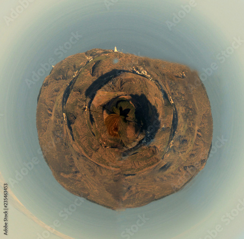 Beautiful spherical panorama with rocks, blue sky and white lighthouse photo