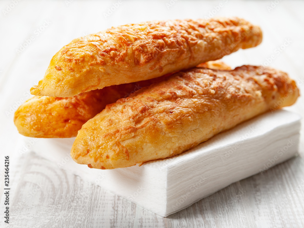 cheese buns, bread with cheese on a white wooden background cheese buns, bread with cheese on a white wooden background