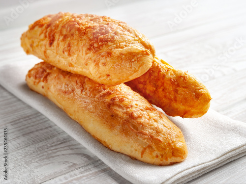 cheese buns, bread with cheese on a white wooden background