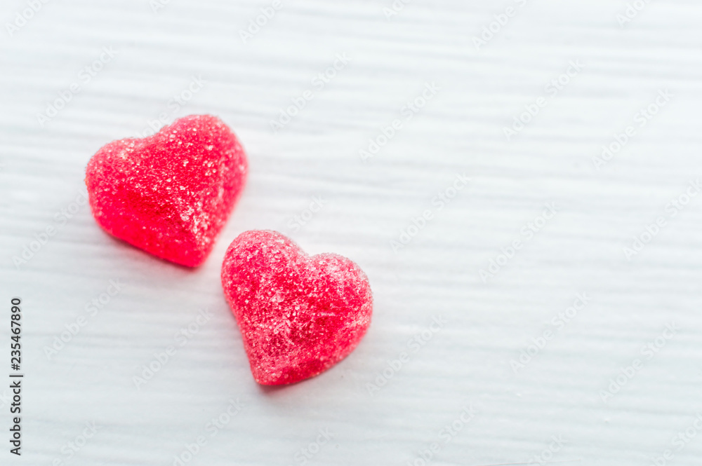 Fototapeta premium Two small red hearts on a white background. Greeting card. Valentine's Day