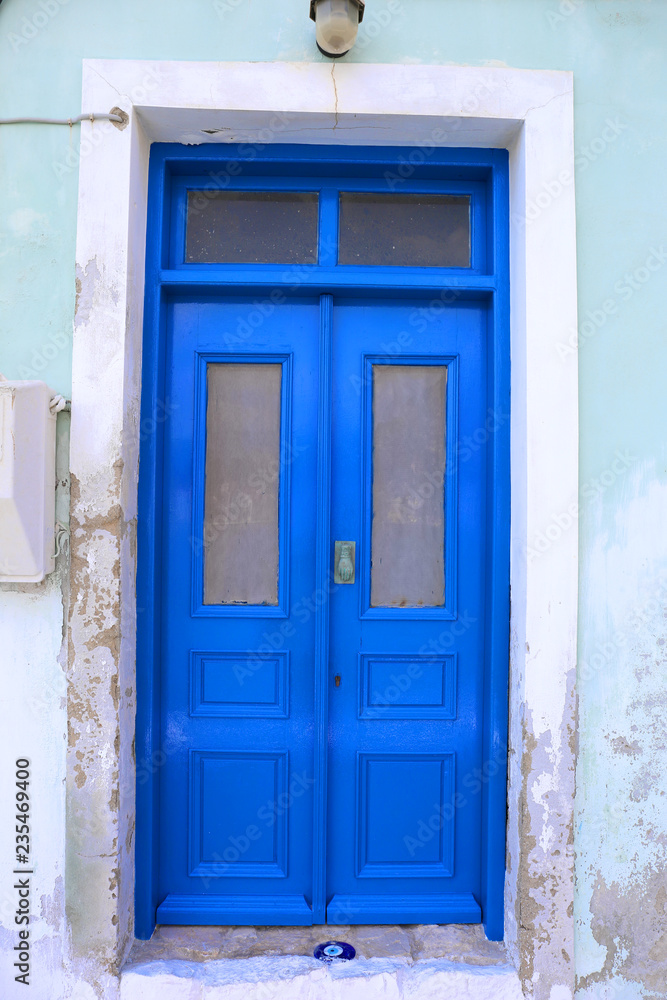 Blue Door with Evil eye charm in Kastellorizo,Greece Blue Door with Evil eye charm in Kastellorizo,Greece