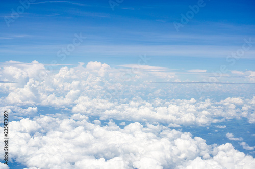 Top view on plane of Blue sky and white puffy clouds.
