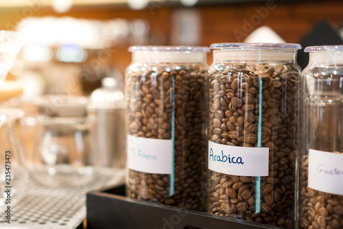 coffee beans with name arabica label in bottle at coffee shop, Selective focus.