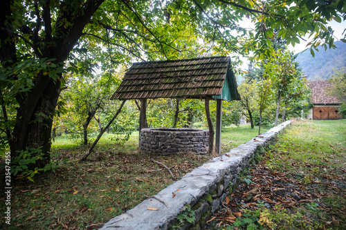 Abandoned well in the forest. Waiting for a terrible girl with a long hair. Halloween concept. Selective focus