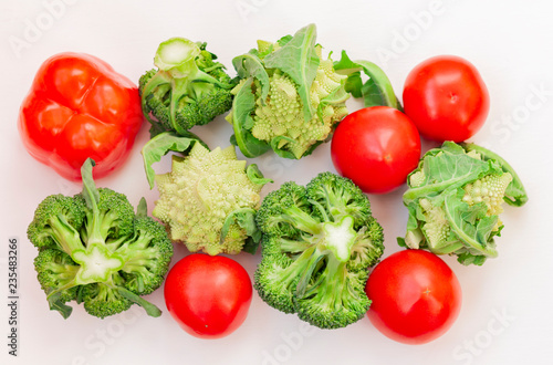 Ripe vegetables tomatoes romanescu broccoli on white wooden background with copy space for your text