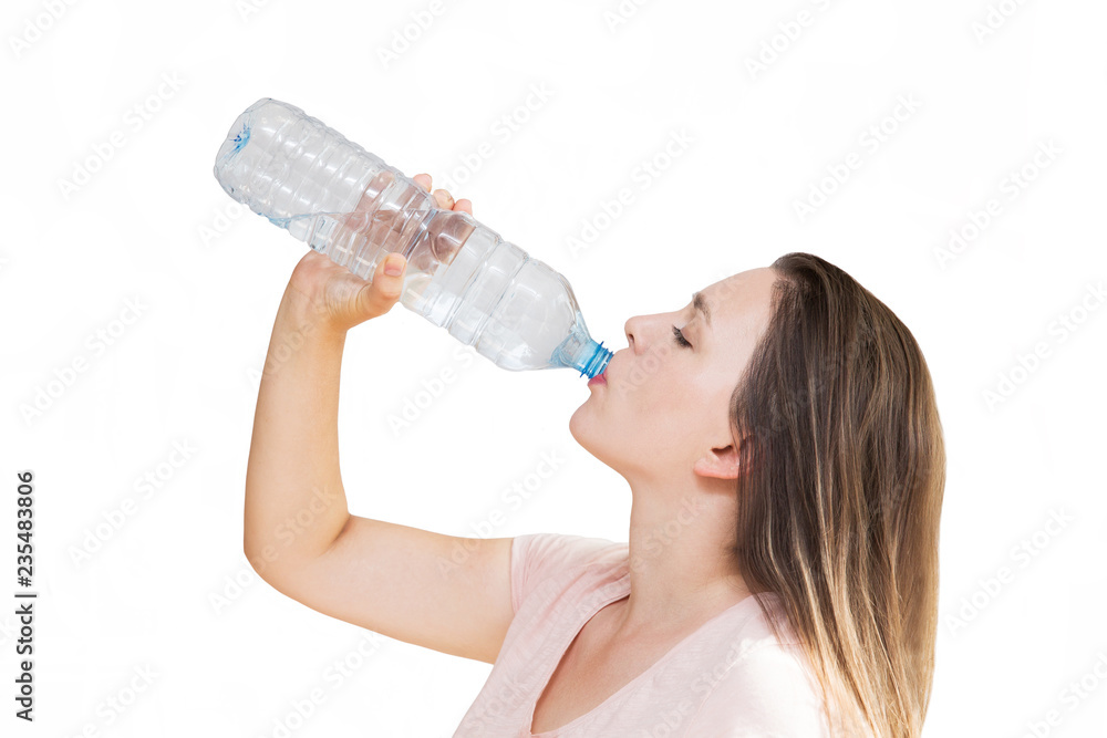 Young woman drinking water from bottle on white background. Girl holding bottle in hand Young woman drinking water from bottle on white background. Girl holding bottle in hand