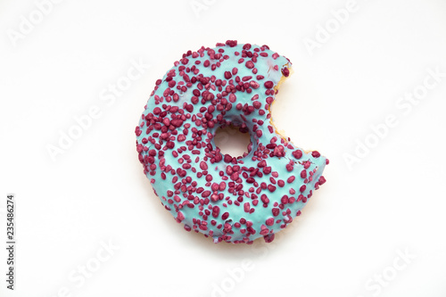 blue stuffed donut with colorful sprinkles isolated on white background. Top view.