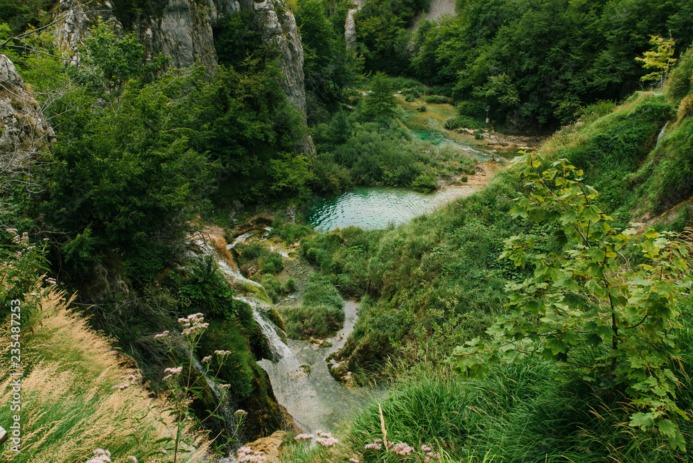 Travel to Croatia. Top view of the Plitvice Lakes - a popular Croatian national park of incredible beauty with lots of greenery, lakes and waterfalls Travel to Croatia. Top view of the Plitvice Lakes - a popular Croatian national park of incredible beauty with lots of greenery, lakes and waterfalls