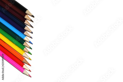 colored pencils are on the side of a blank sheet of paper
