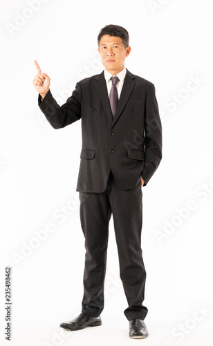 Business man in black suit standing and pointing