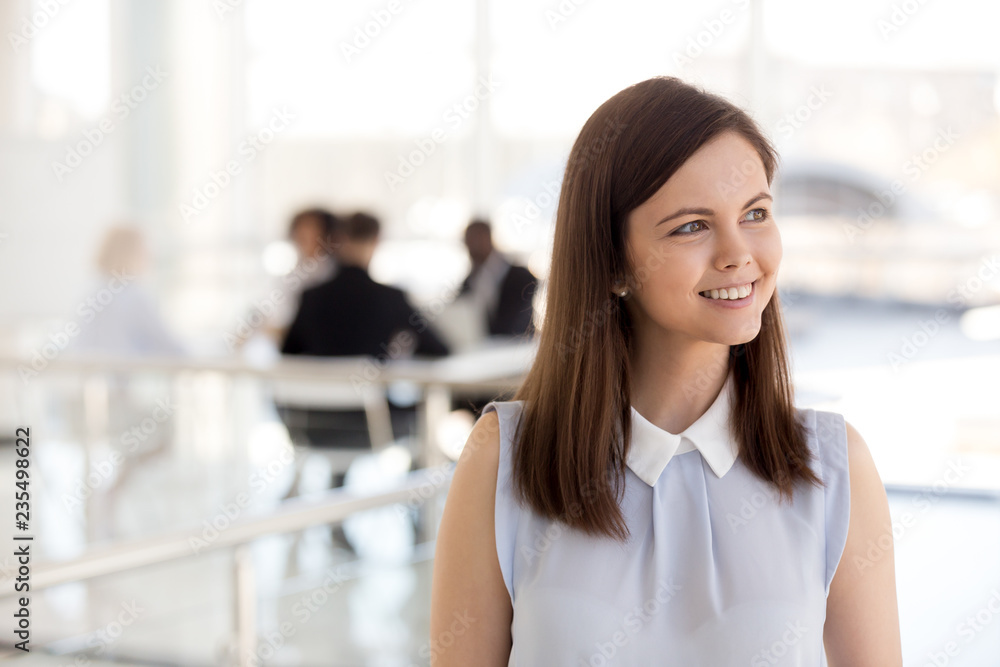 Young smiling intern looking away dreaming of success, ambitious millennial female employee business woman office worker thinking of good career opportunity, planning new goals, future vision concept